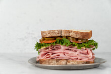 Deli Sandwich With Drink On A Light Surface
