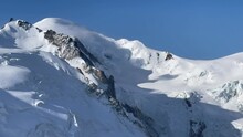 4K French Alps Mountains Peaks Panorama View With 4810m Mont Blanc And Mont Maudit 4465m Summits From Aiguille Du Midi 3842m Viewpoint. Beauty Of Nature And Extreme People Activity Concept