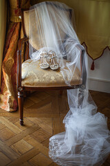 Poster - Wedding shoes with veil on vintage armchair