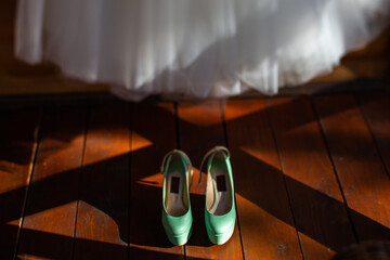 Wall Mural - Turquoise wedding shoes stand on a wooden floor