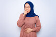 © Bangun Stock Photo - young Asian muslim woman in pink shirt feeling unwell and coughing isolated over white background. People religious lifestyle concept