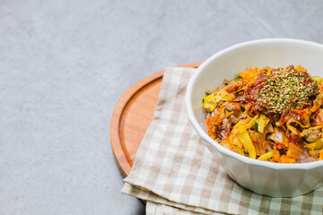 Wall Mural - Korean food Bibimbap, Rice topped with sautéed beef and a variety of colorful vegetables that is mixed at the table with spicy gochujang. A hint of sesame oil helps bring out the flavor.