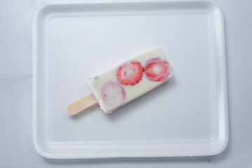 A top down view of a strawberries and cream paleta.