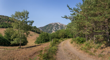 Canvas Print - Scenic summer landscape panorama with dirt road at Col du Blaou or Blaou Pass between Gincla and Salvezines in the Aude Pyrenees mountains, France