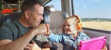 Dad And Daughter Feest Bumping On The Train, Summer, UK, Britain