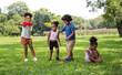 © chachamp - African American kids play frisbee in the park