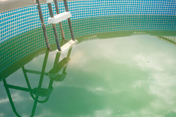 Above ground pool with a problem of green algae (chlorophyta) in the water.