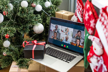 A Happy Family With A Child Is Celebrating Christmas With Their Friends On Video Call Using Webcam. Family Greeting Their Relatives On Christmas Eve Online. New Normal Virtual Event.