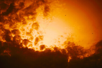 Wall Mural - black orange yellow sky with clouds. dramatic golden color sunset. sunlight. a storm is coming. back