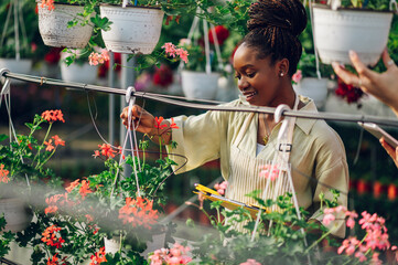 African woman working in a greenhouse flower plant nursery