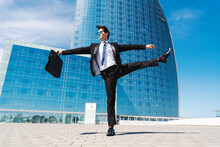 Flexible And Cool Businessman Doing Acrobatic Trick