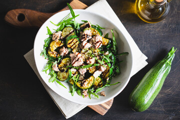 Wall Mural - fresh salad with arugula, baked zucchini and tuna. the concept of healthy and nutritious food