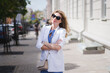 © bisonov - Stylish beautiful business woman in a white jacket on the street