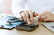 © Thapana_Studio - Healthcare and health insurance business information, doctors use calculators and calculate medical expenses and analyze medical reports.