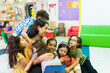 © AntonioDiaz - Excited little kids feeling happy to see their teacher at school