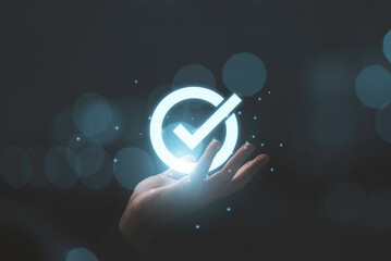 Fototapete - Hand holding virtual glow correct sign and tick correct mark to approve document and project concept.