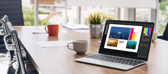 Graphic designer software for modern design of web page and commercial ads showing on the computer screen
