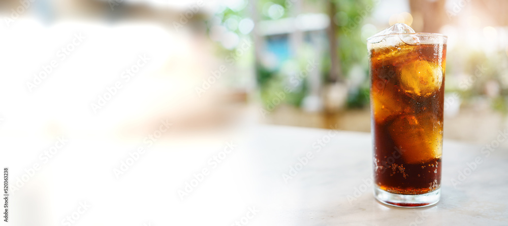 Close up shoot with copyspace of cola soda with ice in a drinking glass ...