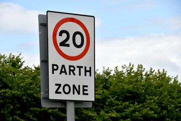 Bilingual road sign showing a 20 mph speed limit at the approach to a village in Wales