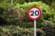 Road sign showing a 20 mph speed limit at the approach to a residential area