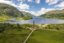 The Drone Aerial View Of Glenfinnan Monument And Loch Shiel. Glenfinnan Is A Hamlet In Lochaber Area Of The Highlands Of Scotland.