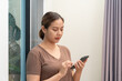 © littlestocker - Asian woman using mobile phone. Business online social media concept.