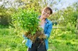 © Valerii Honcharuk - Beautiful middle aged woman with rooted phlox paniculata plant looking at camera