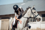 Young teenage girl equestrian showing love and care to her favorite horse. Dressage outfit