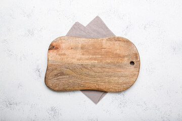 cutting board with light towel on cement background. top view