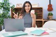 © Krakenimages.com - Young teenager girl studying using computer laptop smiling happy pointing with hand and finger to the side