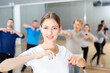 © JackF - Portrait of young emotional woman doing exercises during group class in dance center