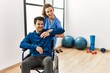 © Krakenimages.com - Young disabled man making mobility exercise sitting on wheelchair at the clinic.