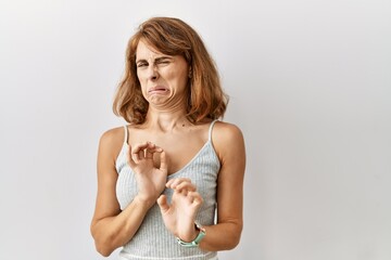 Sticker - Beautiful caucasian woman standing over isolated background disgusted expression, displeased and fearful doing disgust face because aversion reaction.