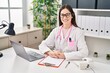 © Krakenimages.com - Young woman wearing doctor uniform working at clinic