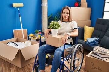 Poster - Young woman sitting on wheelchair moving to a new home skeptic and nervous, frowning upset because of problem. negative person.