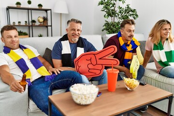 Poster - Group of middle age friends watching and supporting soccer match at home.