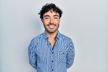 Wall Mural - Young hispanic man wearing casual clothes with a happy and cool smile on face. lucky person.