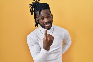 Poster - African man with dreadlocks wearing turtleneck sweater over yellow background beckoning come here gesture with hand inviting welcoming happy and smiling