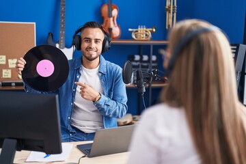 Sticker - Man and woman musicians listening to music holding vinyl disc at music studio