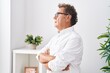 © Krakenimages.com - Middle age man standing with serious expression and arms crossed gesture at home
