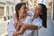 © Krakenimages.com - Two women mother and daughter smiling confident hugging each other at street