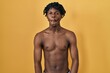 © Krakenimages.com - Young african man with dreadlocks standing shirtless making fish face with lips, crazy and comical gesture. funny expression.