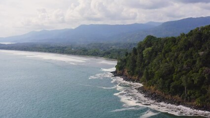 Wall Mural - Aerial Drone View of Rainforest and Ocean on the Pacific Coast in Costa Rica, Tropical Jungle Coastal Landscape Scenery with the Sea and Coastline at Ballena Marine National Park