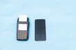 © Boijonell - closeup of mobile smartphone and pos machine place on a blue background