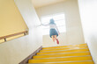 学校 階段をかけ上がる女子高生