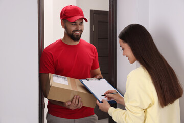 Canvas Print - Woman signing for delivered parcel at home