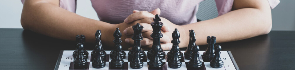 Wall Mural - The chess board shows leadership, Hand of businesswoman moving, chess in competition shows leadership, followers, and business success strategies