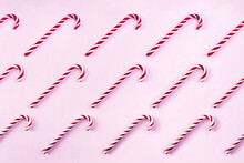 Christmas Striped Candy Cane Isolated On Pink Background. Candy Cane Pattern. Top View