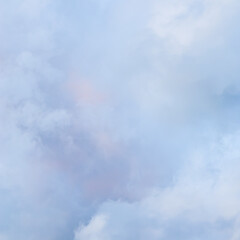 Wall Mural - Cloudy sky background with pale pink clouds at sunset