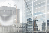Fototapeta Londyn - Beautiful double exposure image of building construction onsite with tower crane heavy machine for real estate property financial business and industry background.